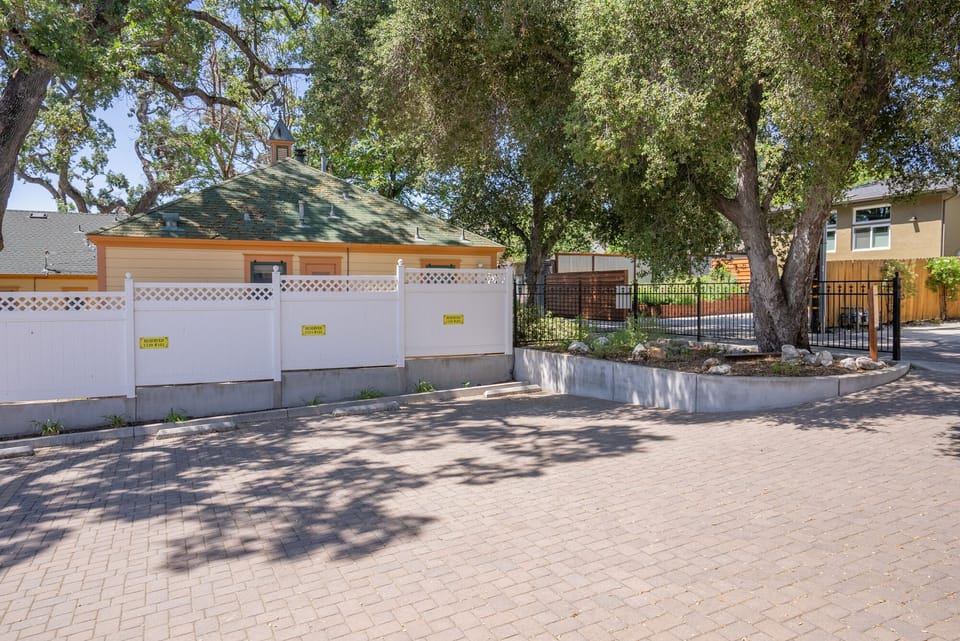 Shaded paver drive gives the home a calm arrival
