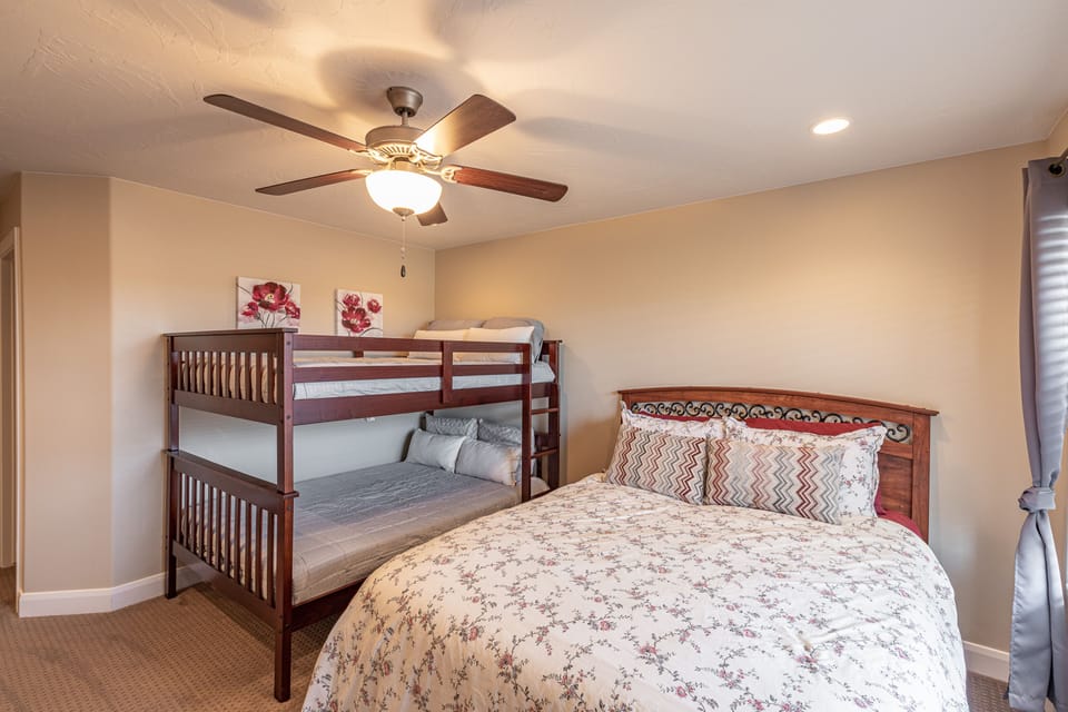 Bedroom 4 - Bedroom 4 is the main bedroom upstairs and includes a Queen bed,  full over full bunk bed, TV, and en suite bathroom