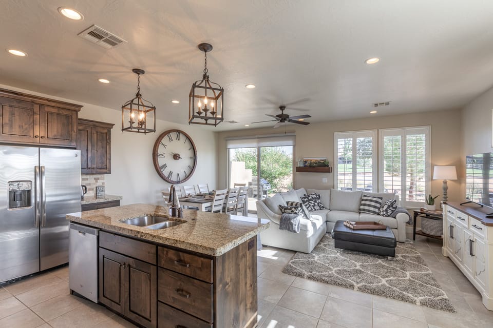 Kitchen View - The living room is conveniently adjacent to the kitchen. There is also access to the back patio which has a BBQ grille suitable for all your favorite BBQ dishes.