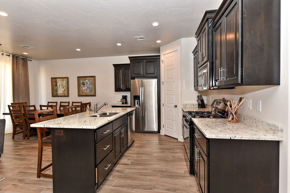 Kitchen  View - Side view of kitchen showing off the beautiful counter tops and stainless-steel appliances.