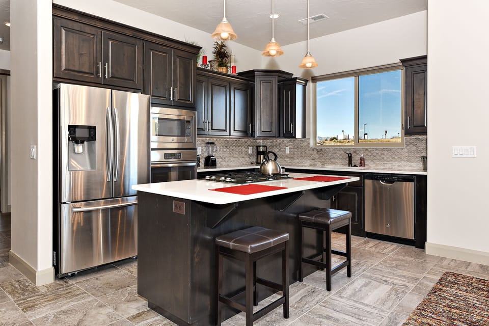 Kitchen - The kitchen is fully stocked with all the dishes, cookware, baking pans, and cutlery you will need for meal preparations and includes stainless steel appliances and granite counter tops.