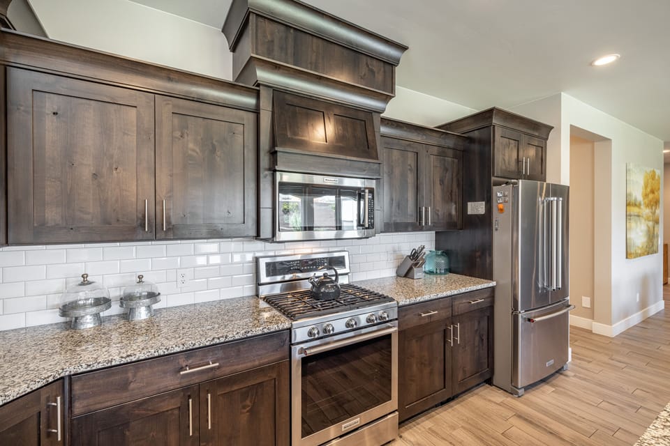 Kitchen - The kitchen is fully stocked with all the dishes, cookware, baking pans, and cutlery you will need for meal preparations and includes stainless steel appliances and granite counter tops.