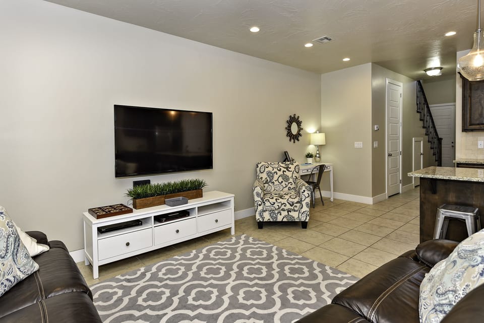 The living room is designed as an open floor-plan and is a great gathering place for meals, games, or watching TV during your stay.