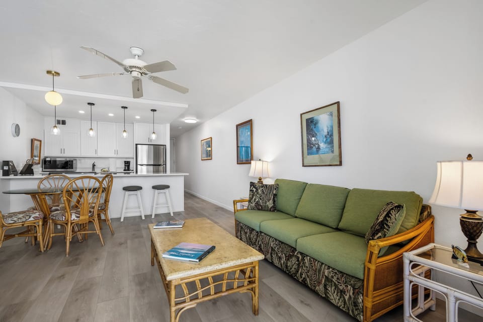 Step into your bright, open-plan living space where coastal charm meets modern comfort. Relax on the cozy sofa or gather at the dining table while you enjoy the fully equipped kitchen ready for your culinary adventures.