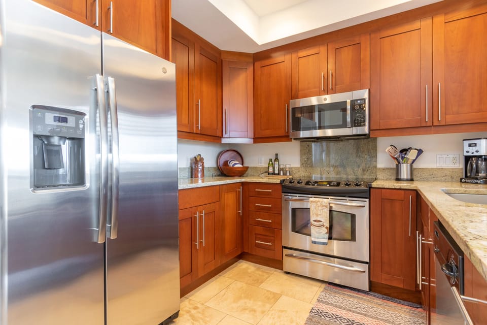 Whip up your favorite meals in a fully-equipped kitchen with modern stainless appliances, rich cabinetry, and granite countertops—everything you need for vacation cooking at your fingertips.