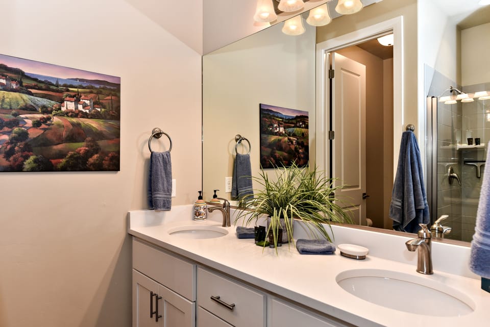 Main Bathroom - The Main bathroom that is adjacent to the Main bedroom is large and luxurious. With his and her sinks, toilet, vanity, walk-in shower and a large walk-in closet.