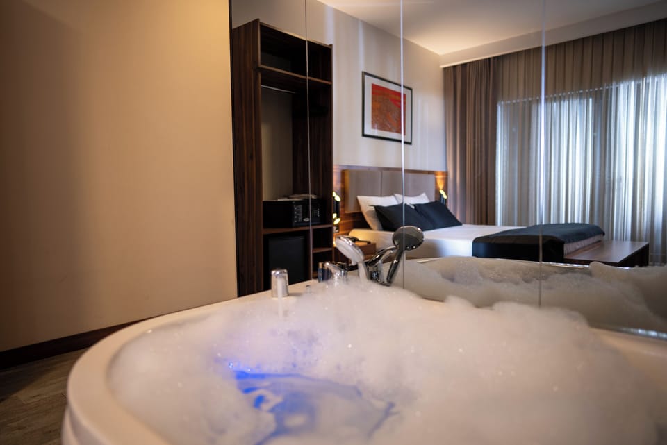 Elite Studio Suite, City View | In-room safe, desk, laptop workspace, iron/ironing board