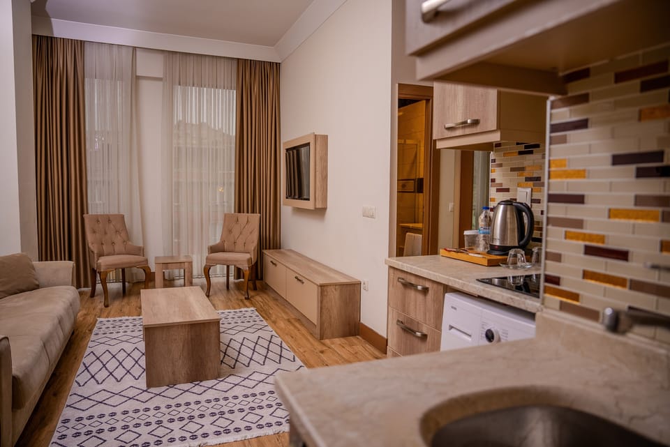 Family Suite, 2 Bedrooms, Kitchenette | Living area | Flat-screen TV