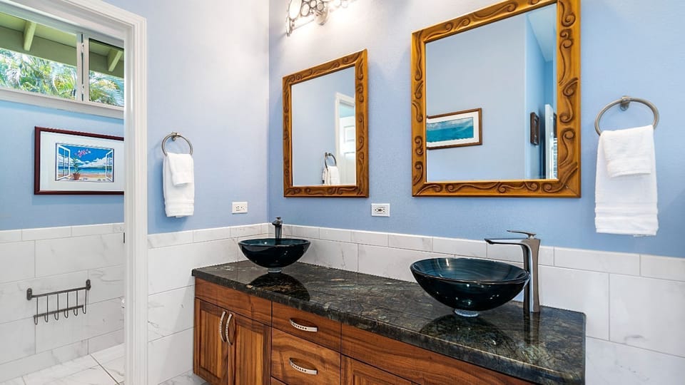 Primary Bathroom of this Kona Hawaii vacation rental with Double Sinks, Walk-In Shower & Clawfoot Tub.
