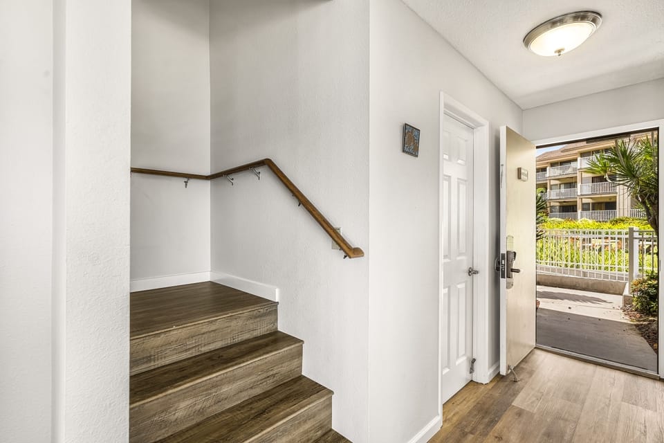 Unit entry, powder room & Stairs leading to bedrooms