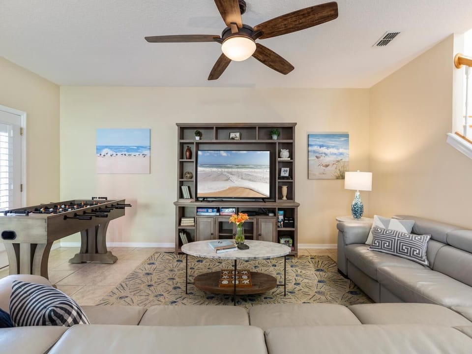 Spacious family room with reclining leather sectional seating and foosball table!