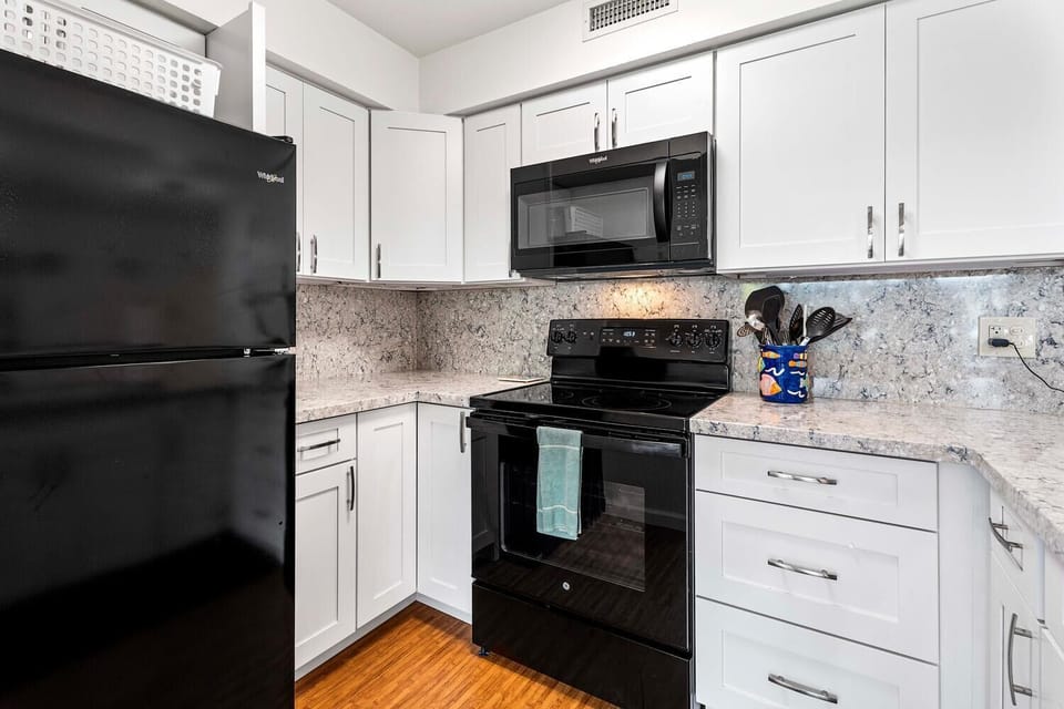 Kitchen with a full fridge/oven