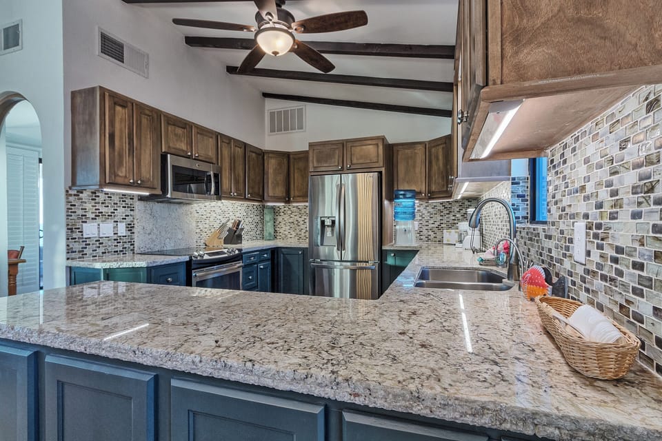 Earth toned backsplash complements the granite