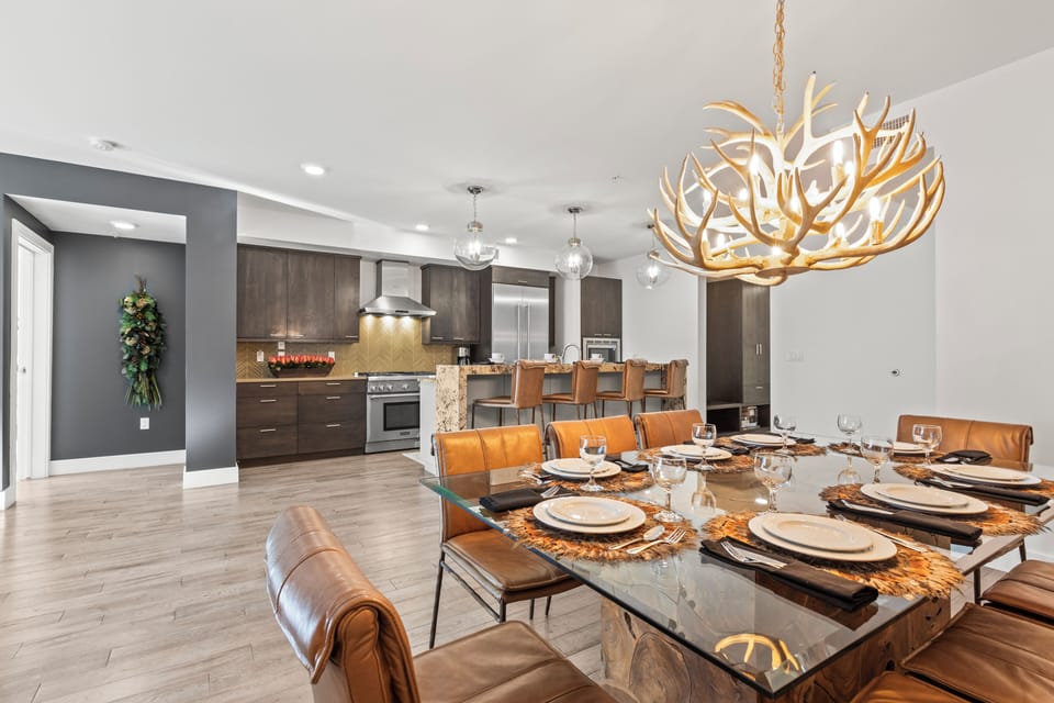 Rio Grande 203 has a stylish dining area with leather chairs and antler chandelier.