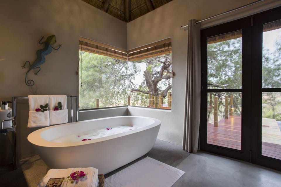 Deluxe Room | Bathroom | Shower, designer toiletries, hair dryer, bathrobes