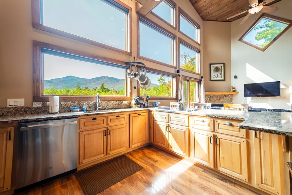 The floor-to-ceiling wall of windows offers an abundance of natural light and amazing views