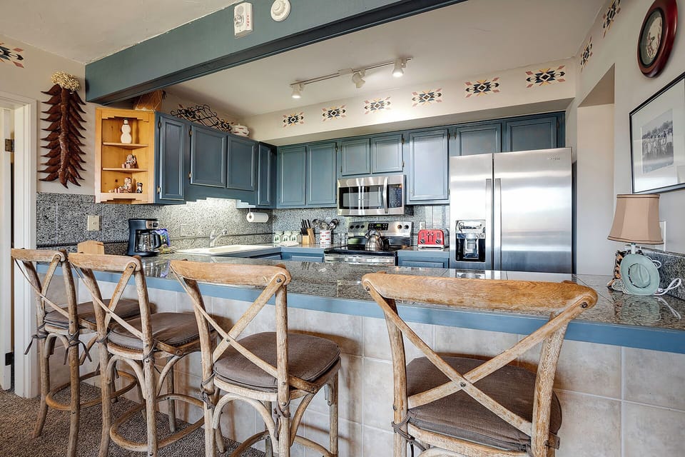 You'll love preparing meals in this fully equipped kitchen with granite counters, breakfast bar seating, and authentic Southwestern charm.