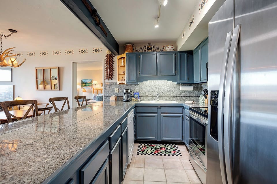 Your fully-equipped kitchen awaits with granite countertops, stainless steel appliances, and thoughtful Southwest touches for memorable meal prep.