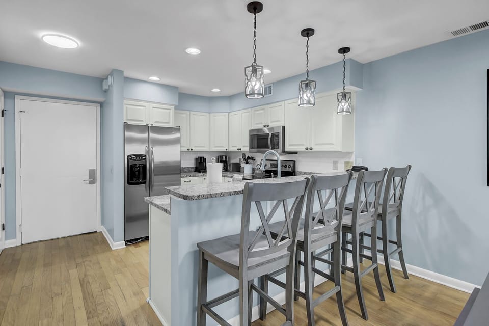 Kitchen features barstool seats.