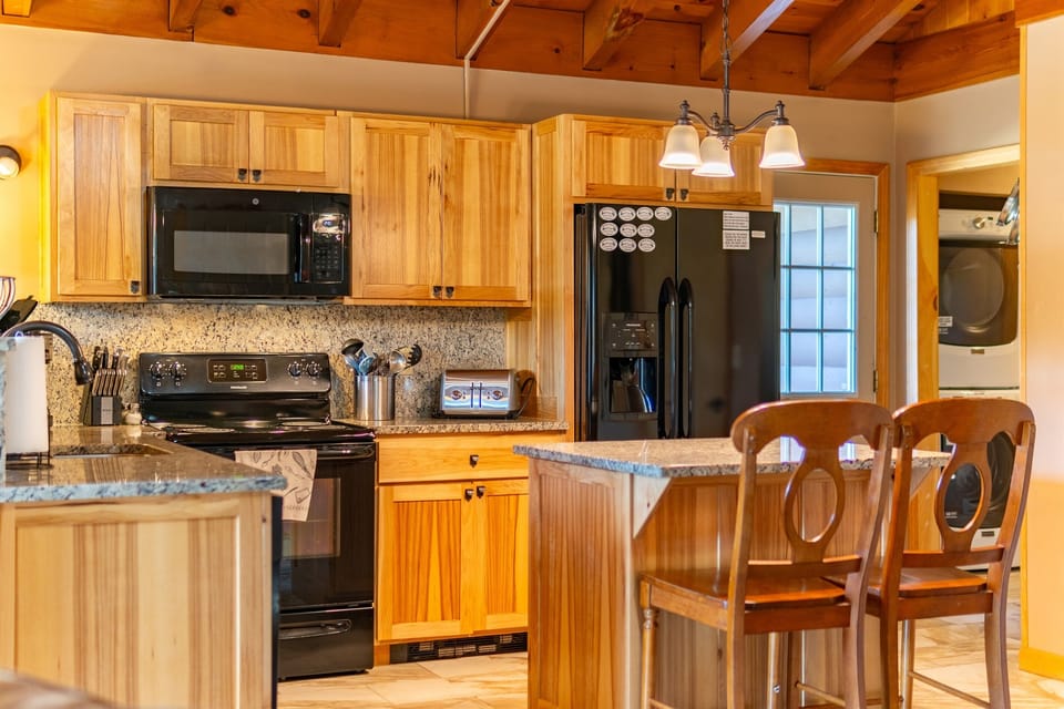 The kitchen has a full complement of tools and appliances.  The dining area has plenty of seating for all of your guests.
