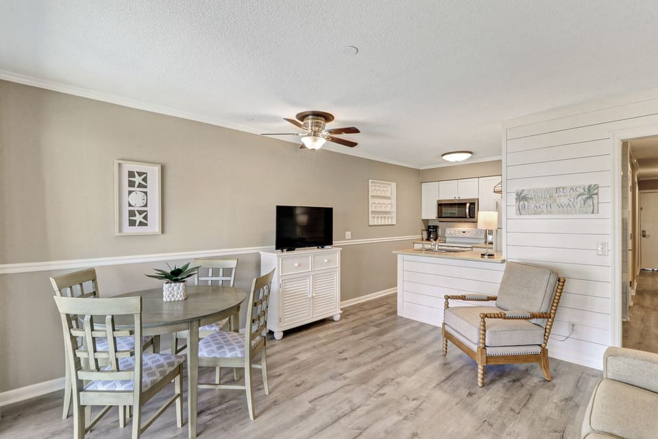 Open Floor Plan - Flat screen TV and comfortable dining for 4 people in this open floor plan.