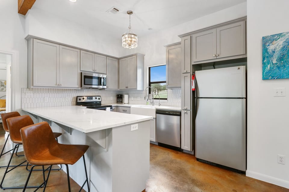 Large kitchen with stove, oven, refrigerator, microwave, and coffee maker