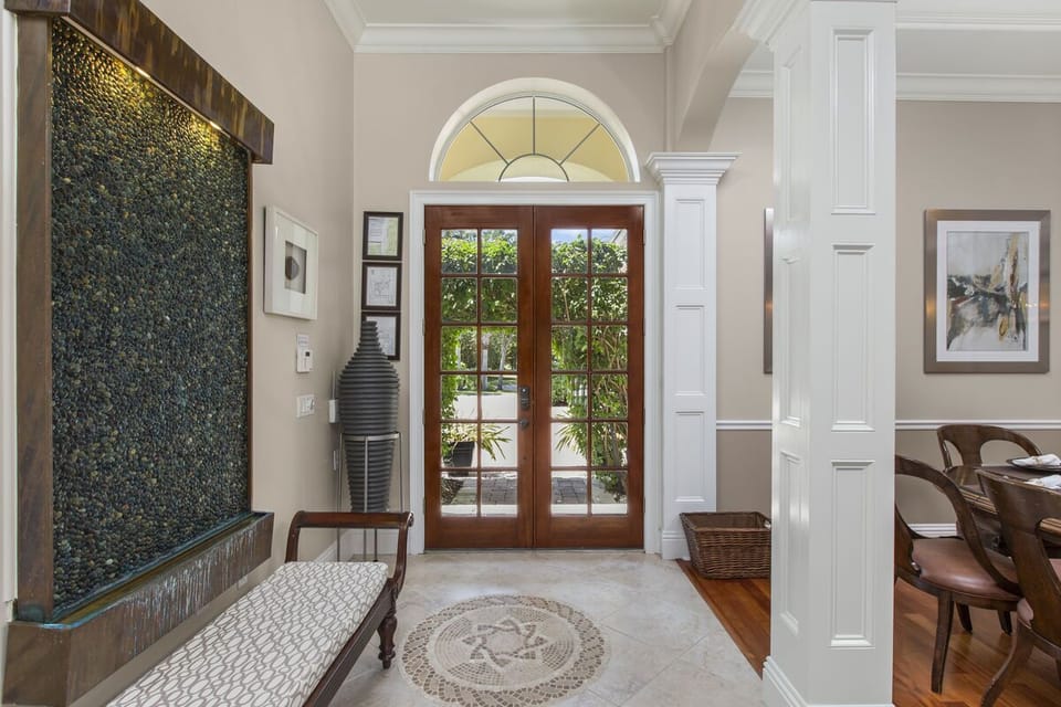 The tranquil waterfall greets you as you enter this spectacular home