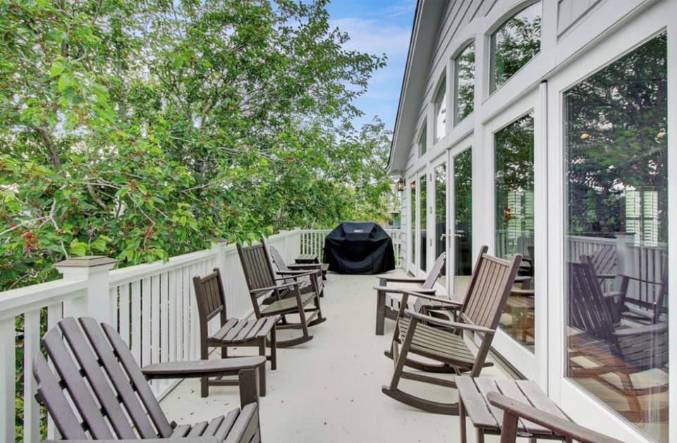 Back porch with rockers & propane grill.