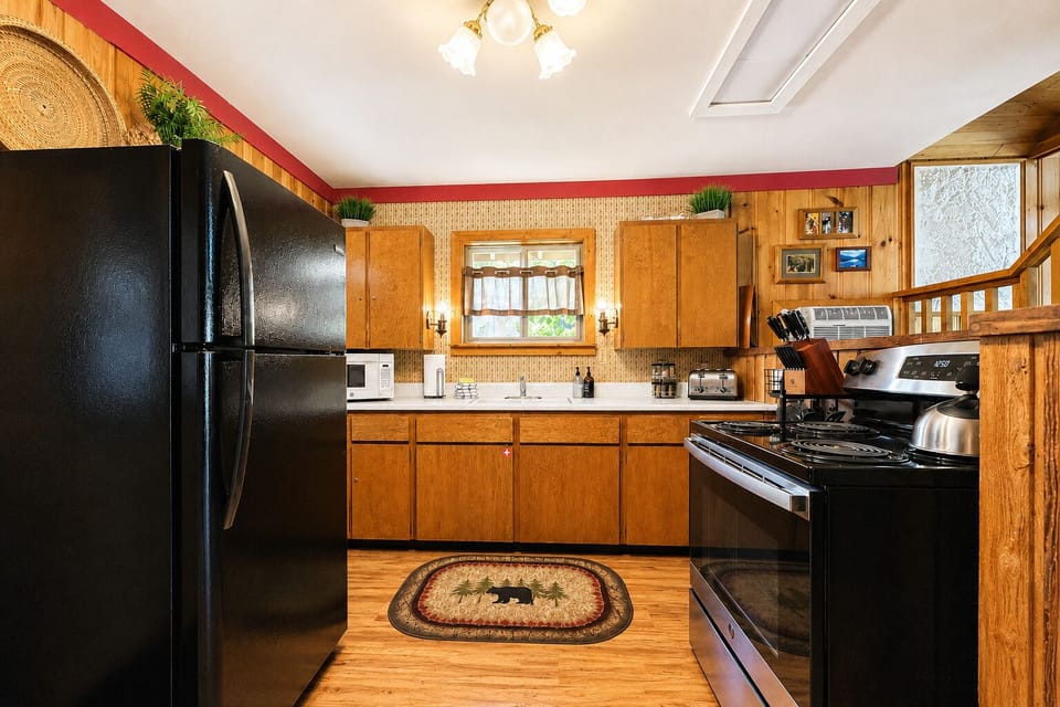 Your fully equipped kitchen features modern appliances and warm wood finishes, ready for you to whip up meals after a day of adventure.