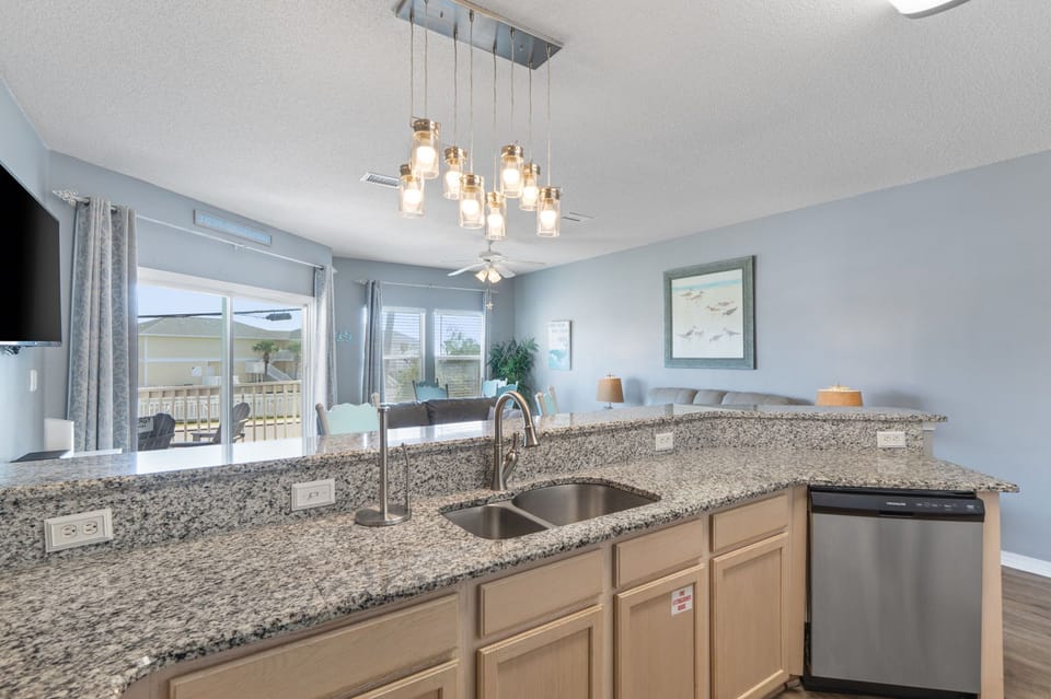 Your modern kitchen features granite countertops, stainless steel appliances, and elegant pendant lighting creating the perfect space for vacation cooking.