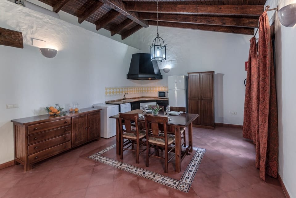 Table and chairs of El Palmeral and Los Naranjos country houses kitchen in Hacienda Roche Viejo in Conil