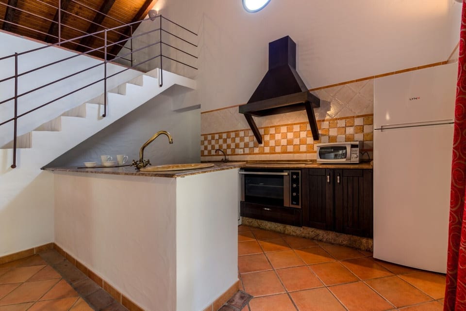Countertop, oven and fridge El Olivo House kitchen in Hacienda Roche Viejo in Conil