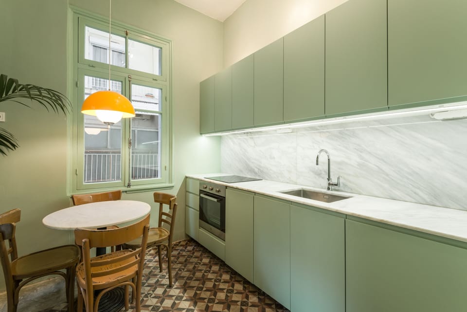The kitchen features an under the counter frigde, a dishwasher, stove, cooktop