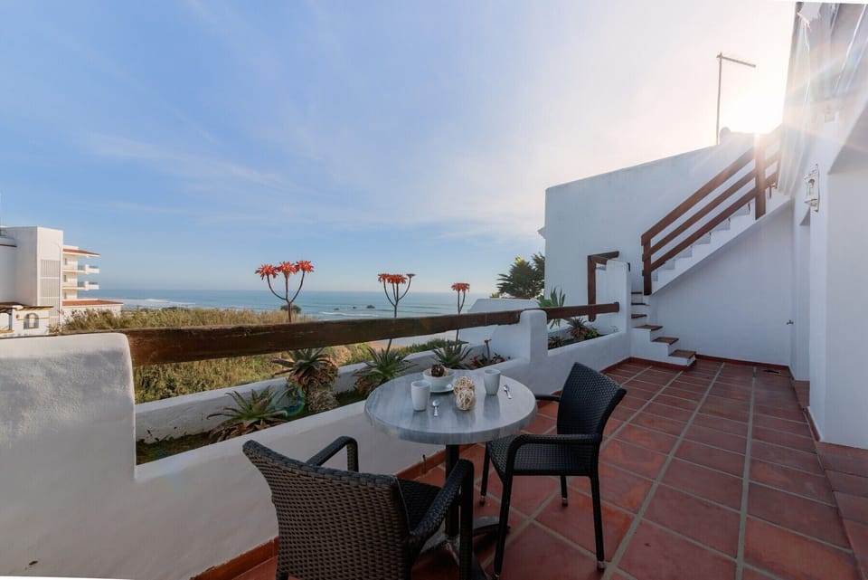 Table and chairs with sea views from Villa Poniente Terrace in Villas Flamenco Beach in Conil