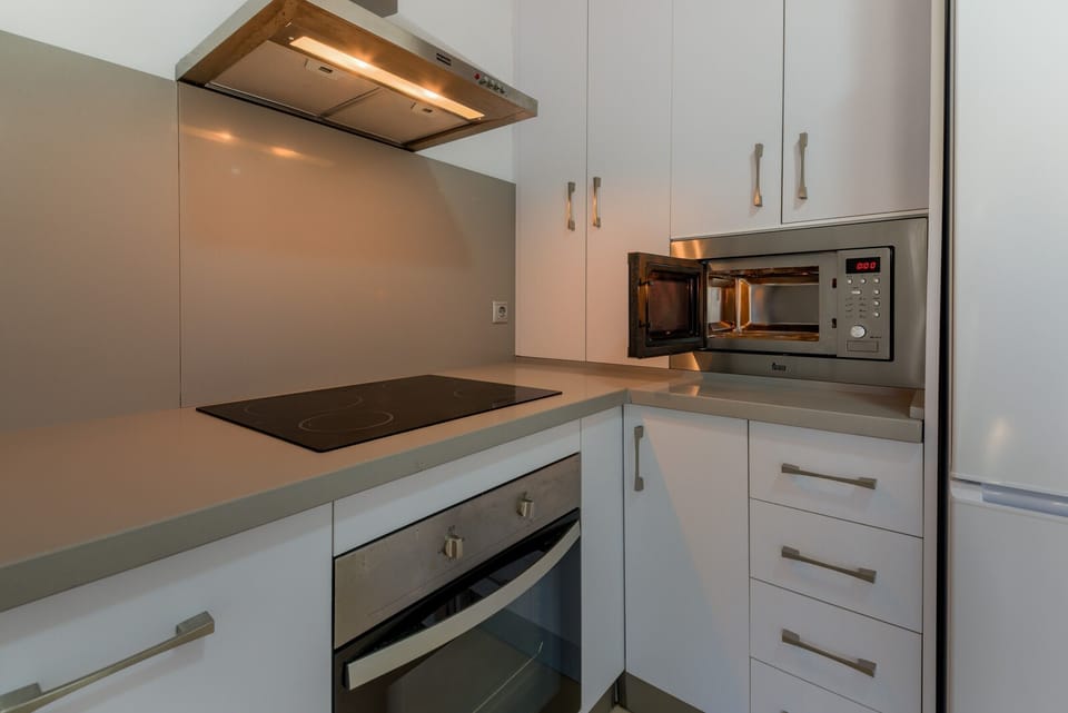 Countertop, oven and microwave of Villa Castilnovo kitchen in Villas Flamenco Beach in Conil