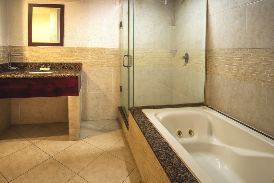 Superior Suite, Partial Ocean View | Bathroom | Shower, towels, soap, shampoo