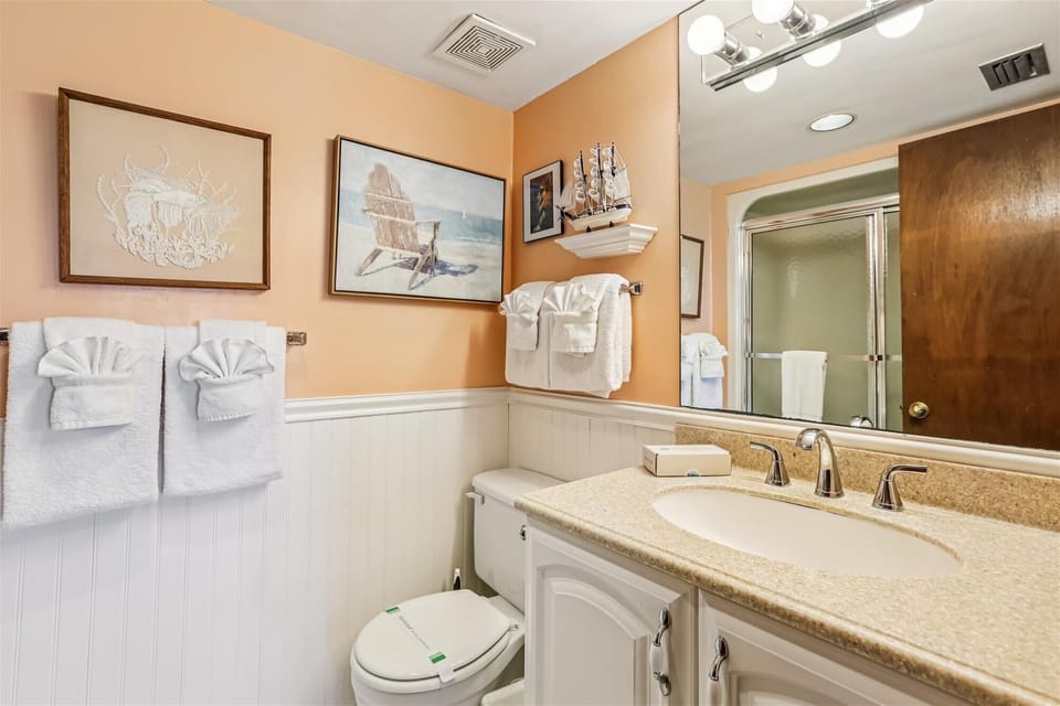 - Bathroom with granite vanity, bright mirror, and lighting  
- Nautical decor and fluffy towels add coastal atmosphere  
- Fresh, clean design for comfort during your stay  
