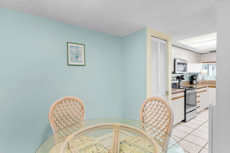 Enjoy meals in your cozy dining nook with wicker chairs, then step into the fully-equipped kitchen for all your culinary needs.