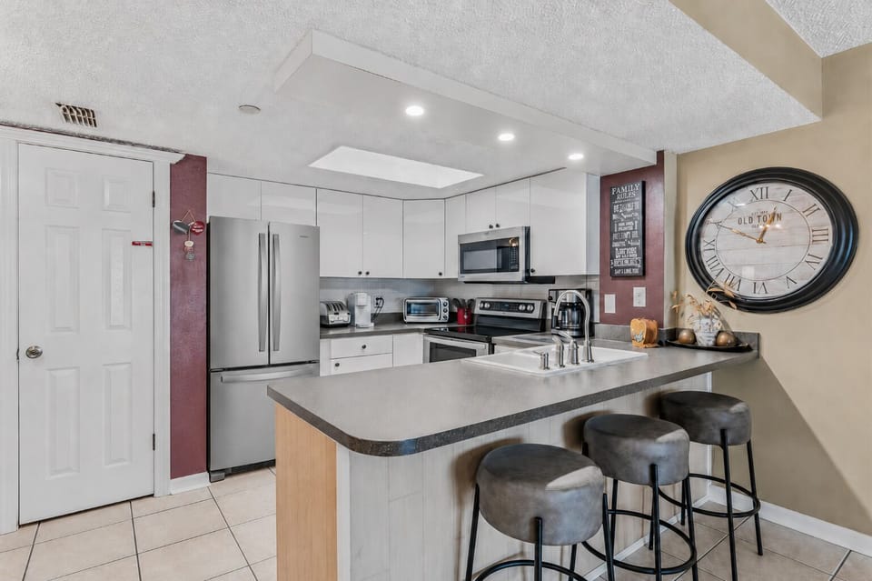 Your fully equipped kitchen invites you to whip up home-cooked meals at the sleek breakfast bar, complete with modern appliances and bright, welcoming countertops.