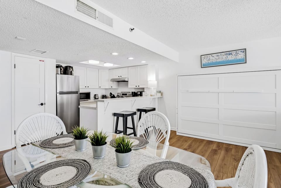 Your bright, open-concept space flows seamlessly from dining to kitchen, where you'll love preparing meals with modern appliances and stylish bar seating.