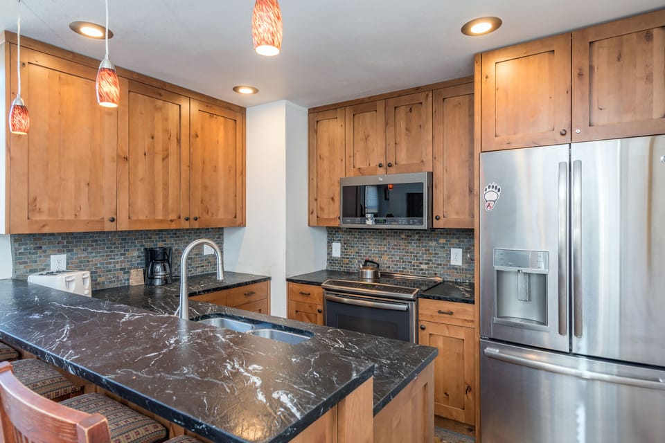 Kitchen with an oven, a refrigerator and a microwave
