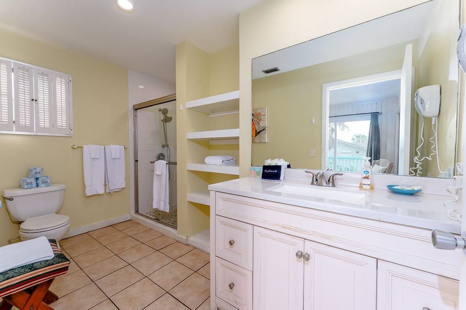The upstairs ensuite bathroom has a modern shower with double shower heads for a relaxing and refreshing moment before a busy vacation day.