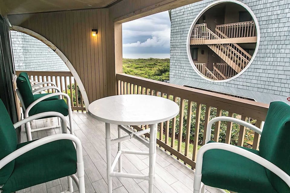 - Relax outdoors with four cushioned chairs and a bistro table on your private balcony
- Enjoy ocean peeks through the breezy coastal architecture surrounding you
- Covered and inviting, it’s the ideal spot for morning coffee or wine