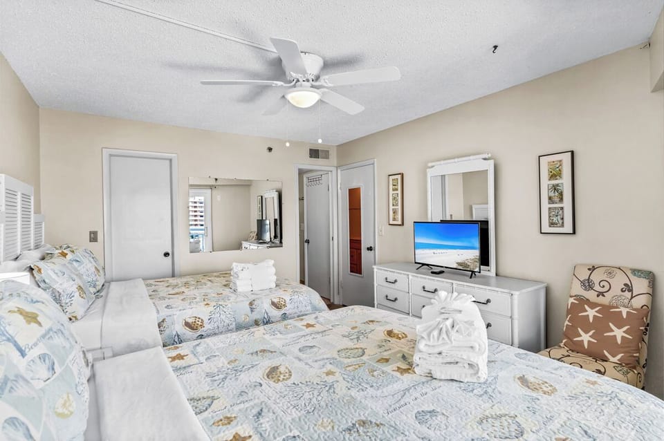 Drift off to peaceful dreams in this comfortable Queen bedroom, complete with ceiling fan and entertainment for restful evenings.