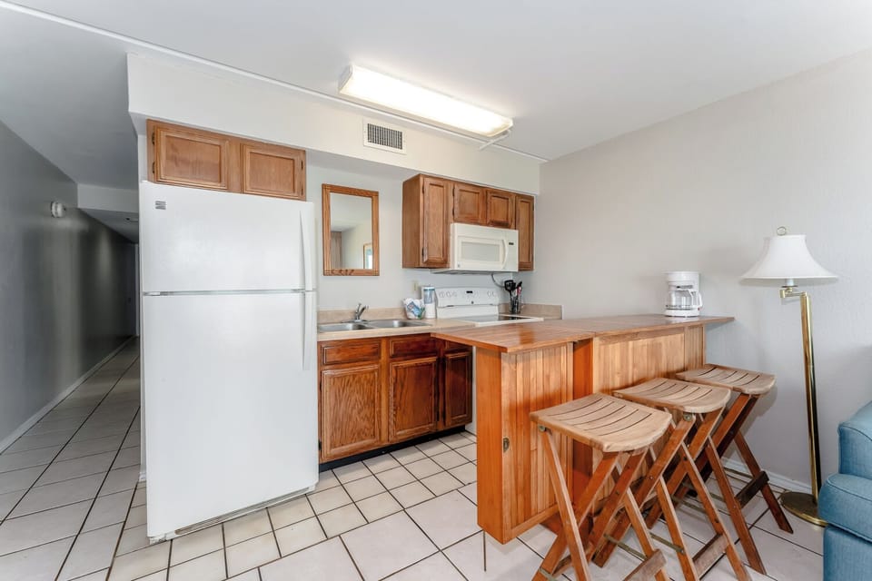 Our cute and cozy kitchen has everything you need to whip up a snack between trips to beach and pool.