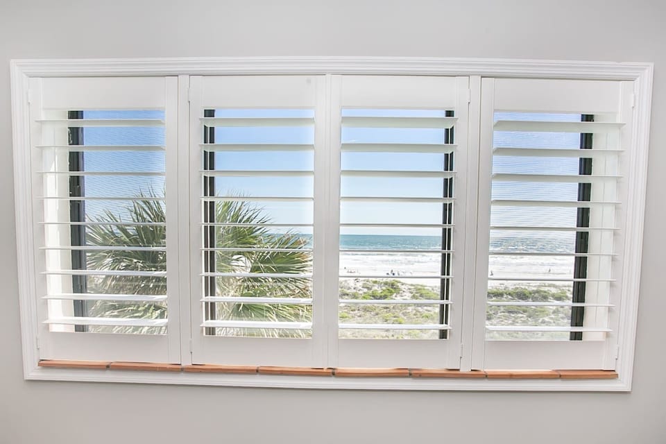 - Window view with shutters overlooking oceanfront dunes and beach  
- Bright natural light fills the room with a refreshing coastal vibe  
- Perfect for enjoying stunning seaside scenery from indoors
