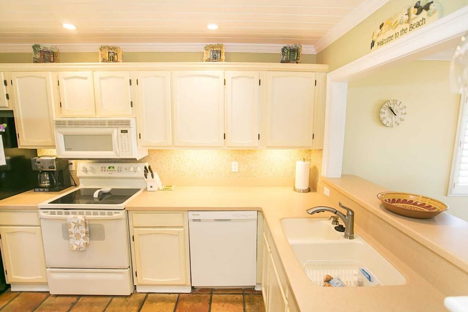 - Spacious kitchen with double sink, dishwasher, and plenty of counter space  
- Under cabinet lighting brightens the room for easy meal prep  
- Fully stocked setup ideal for family dinners or quick snacks
