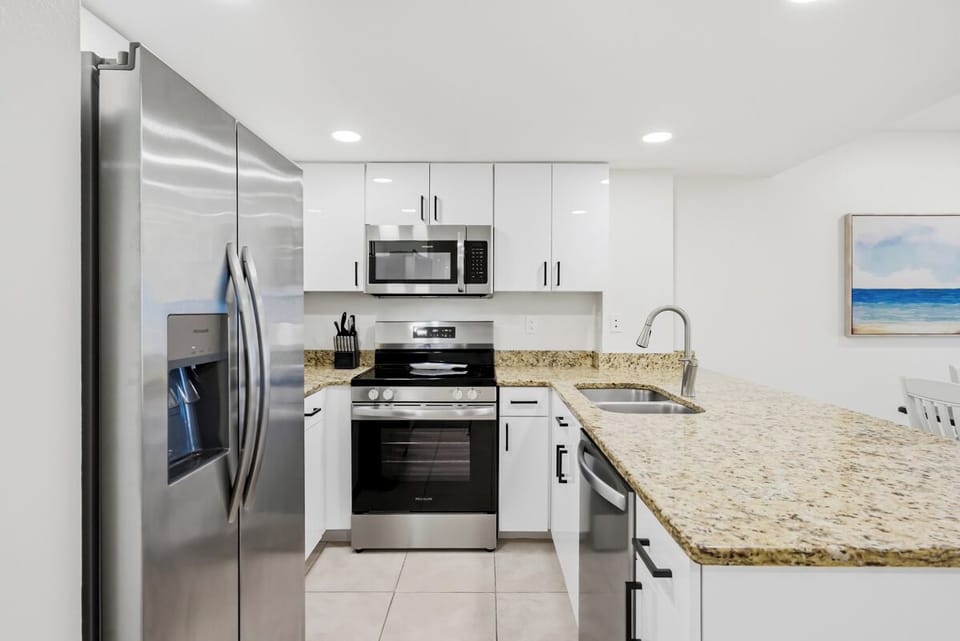 Your modern kitchen features granite countertops, stainless steel appliances, and everything you need to create memorable meals.