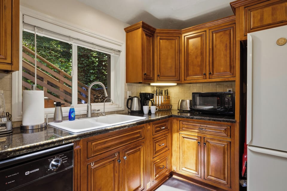 Skylights, windows, overhead, and under cabinet lights all make for a great cooking space with lots of light.