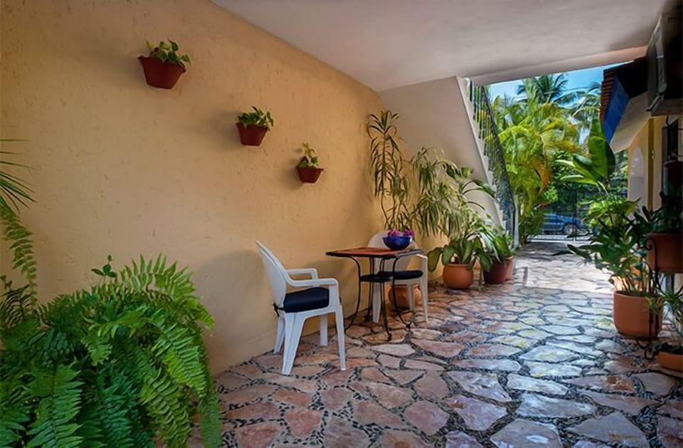 You have a table and 2 chairs to enjoy your morning coffee right outside your apartment